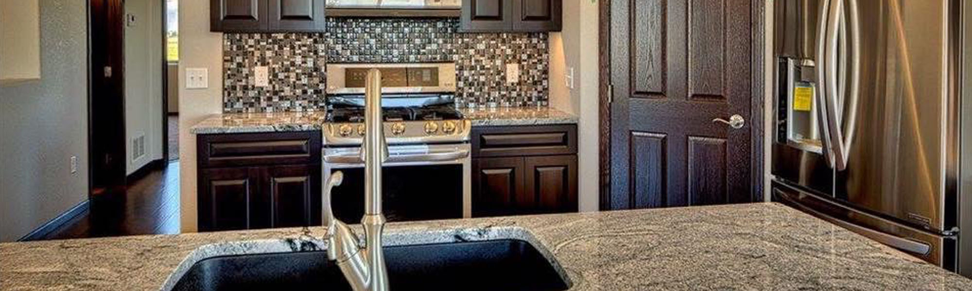 Kitchen with newly installed grey granite countertops.